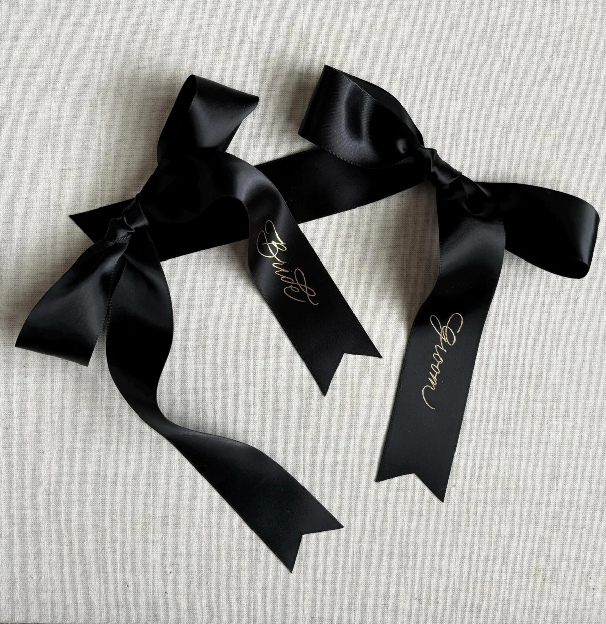 Bride and groom written in delicate hand gold calligraphy on black satin ribbons