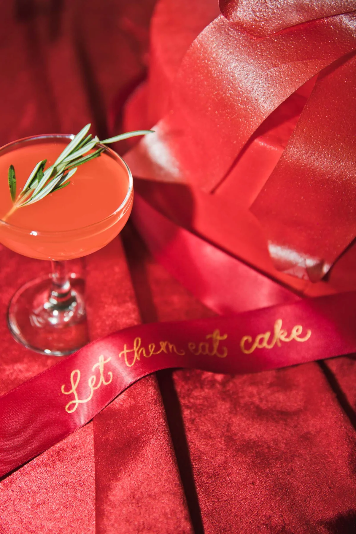 Gold calligraphy wedding cake ribbon on ruby red satin