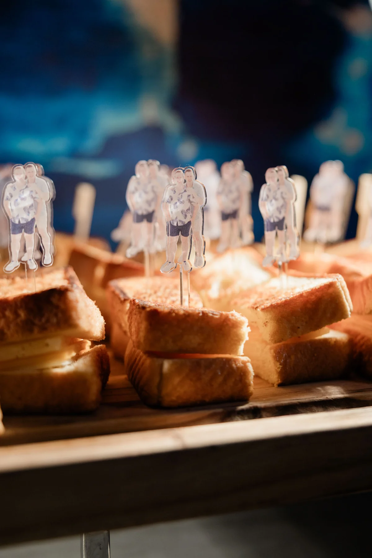 Mini grilled cheese sandwich bites with personalized photo skewers of the couple for late night wedding snack idea