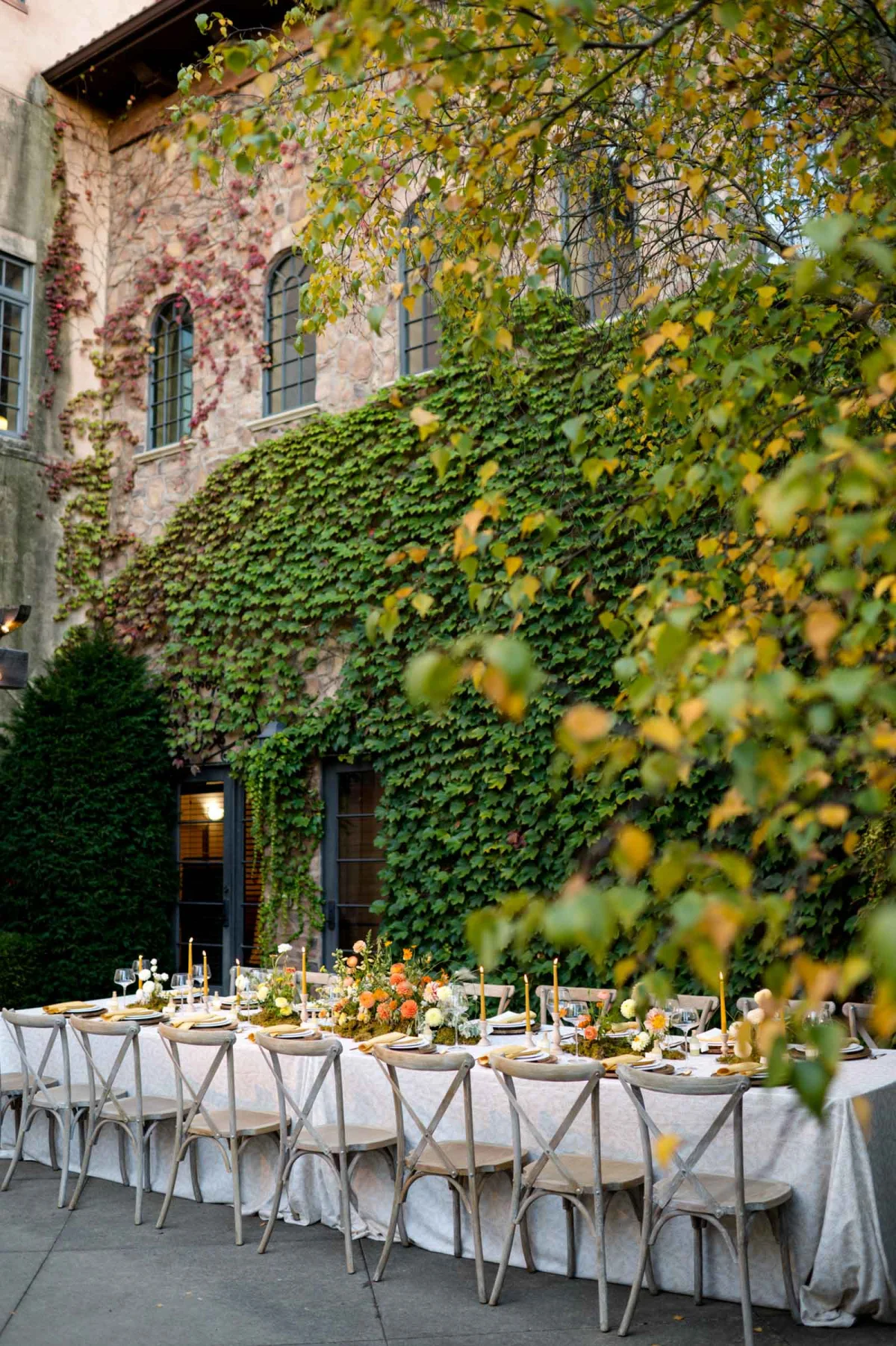 Orange and yellow wedding table decor ideas with candles and low flower centerpieces