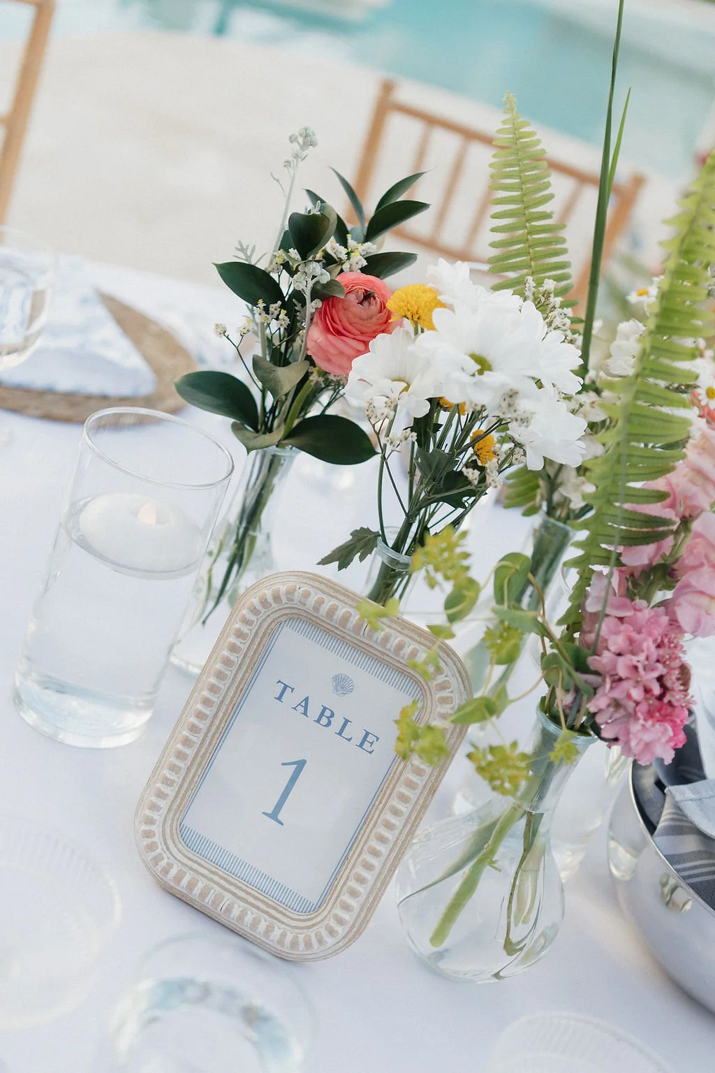 Simple printed wedding table number in a coastal photo frame