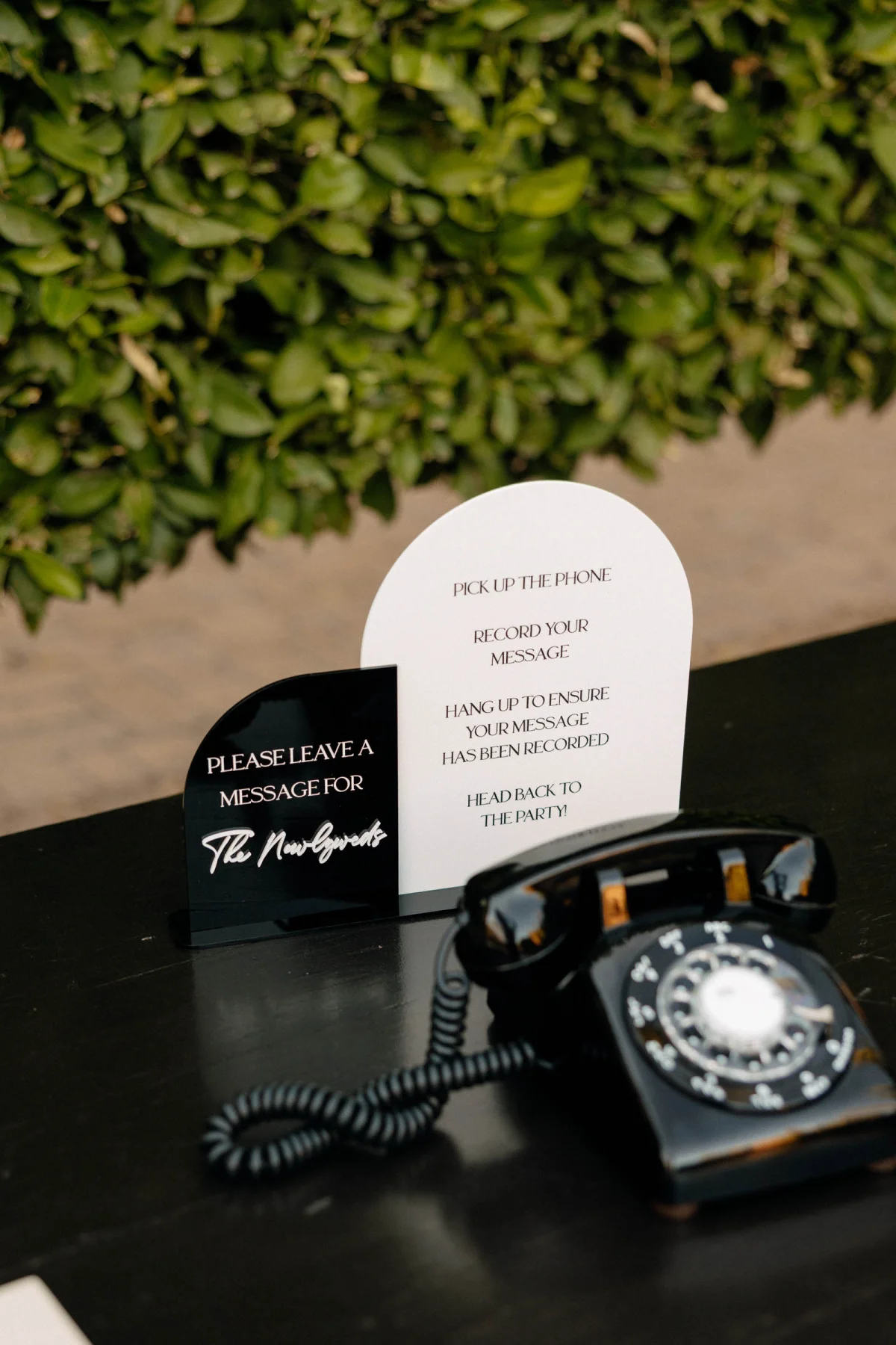 Modern black retro rotary phone for a wedding audio guestbook setup
