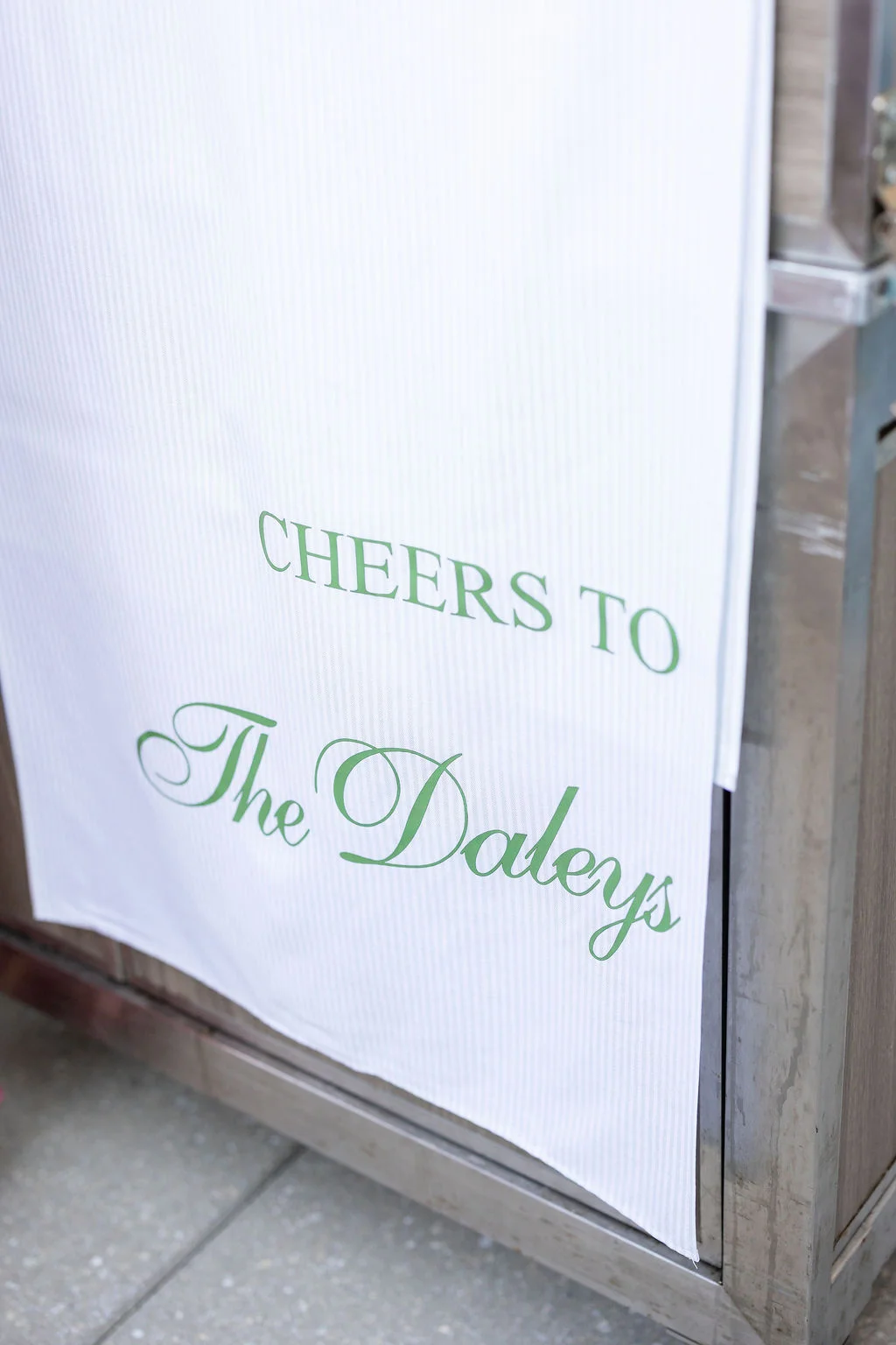 Personalized striped fabric wedding bar sign with green Cheers message made with a Cricut