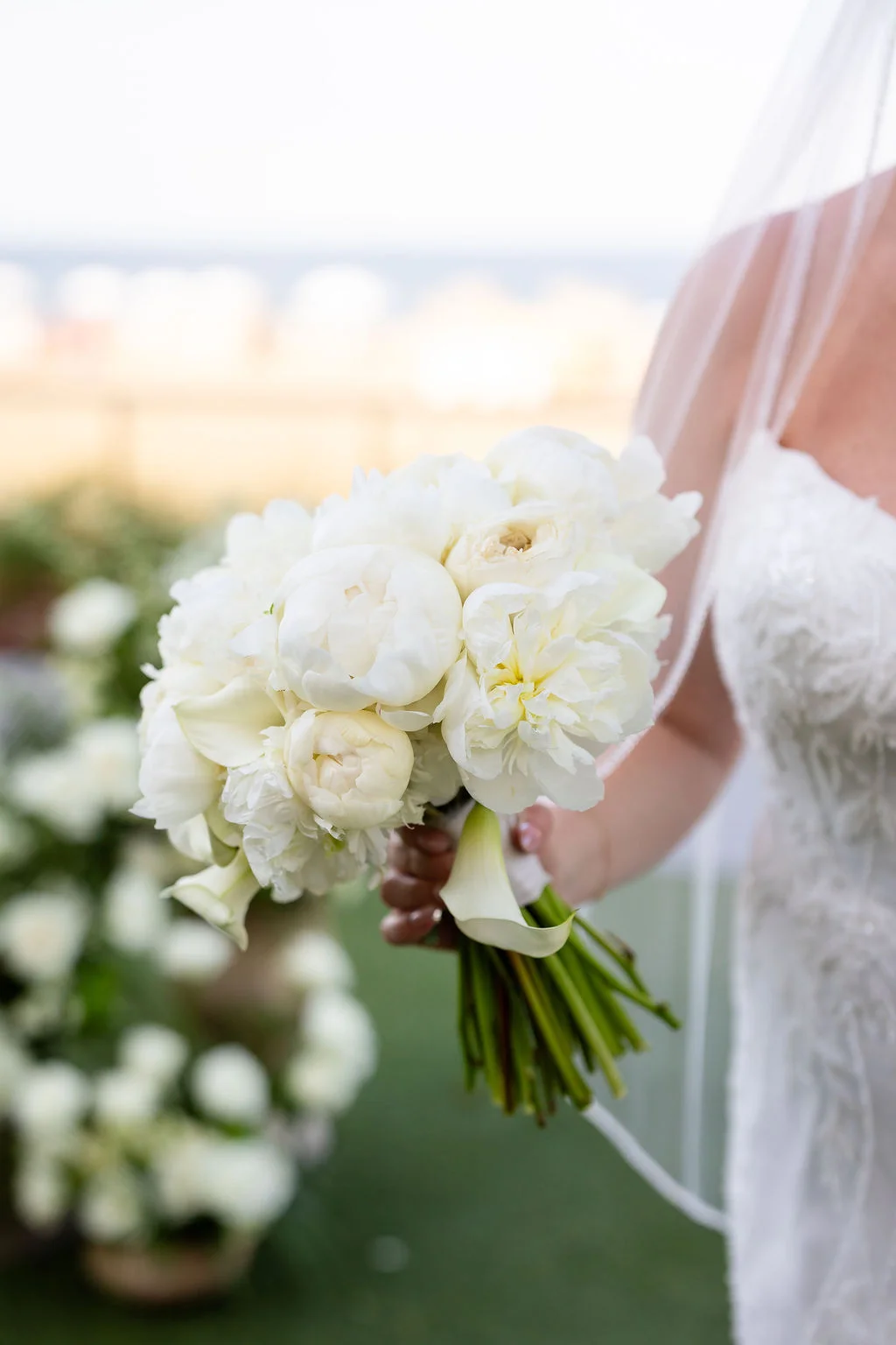 All white wedding bouquet with calla lilies, peonies, and roses