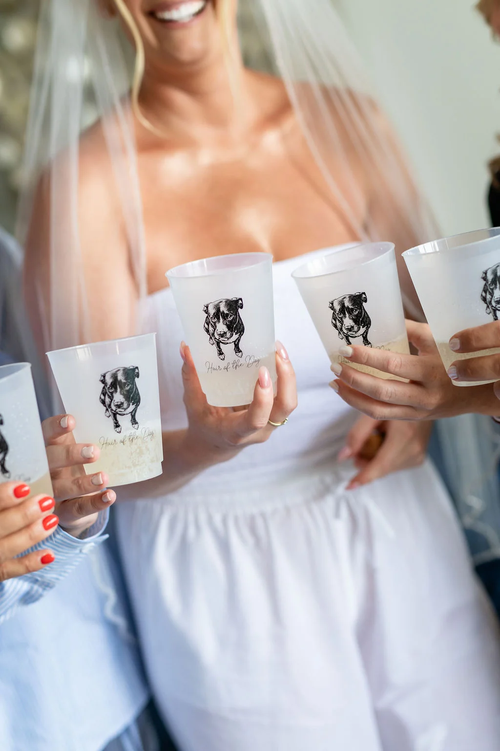 Bride and her friends holding adorable custom cups with an illustration of their dog and the phrase Hair of the Dog