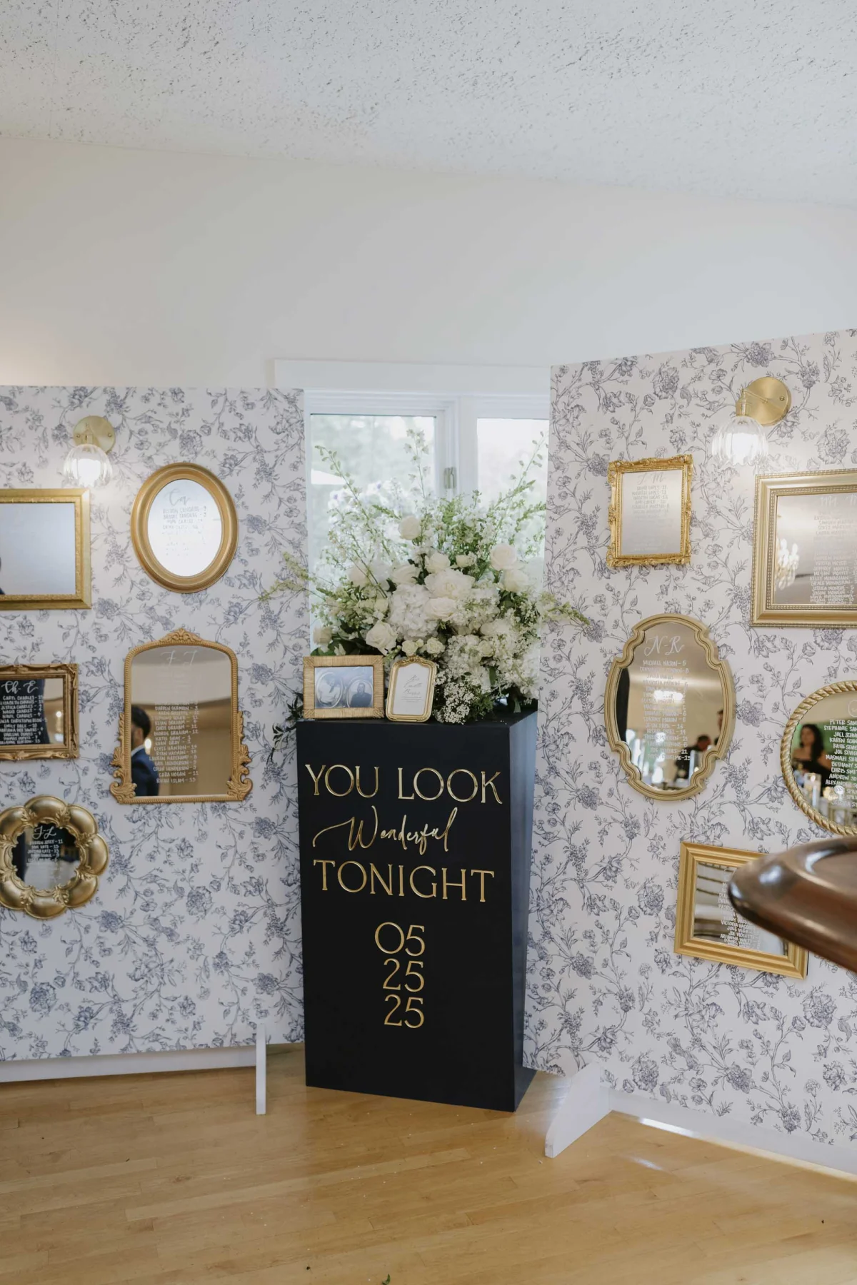 DIY wedding mirror seating chart wall with white calligraphy names