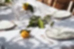 Close-up of wedding table setup showing layered place settings with linen runner and decor for budget wedding table decorations