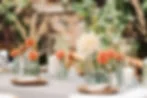 Wedding table with budget-friendly floral arrangement using bud vases and mixed stems as affordable wedding table decorations
