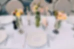 Detailed wedding reception table setup with layered decor elements showing how to self-set up wedding tables beautifully
