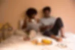 Engaged couple laughing together during wedding planning
Two people reviewing wedding planning notes at a table
Couple sitting together looking relaxed during their engagement