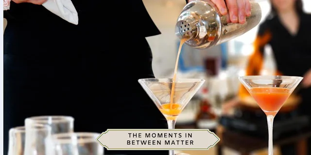 WEDDING COCKTAIL HOUR FLOW Bartender pouring an orange cocktail from a shaker into a martini glass during wedding cocktail hour.